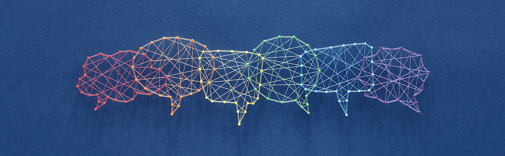 Network of pins and threads in the shape of many interconecting speech bubbles symbolising social dialog.